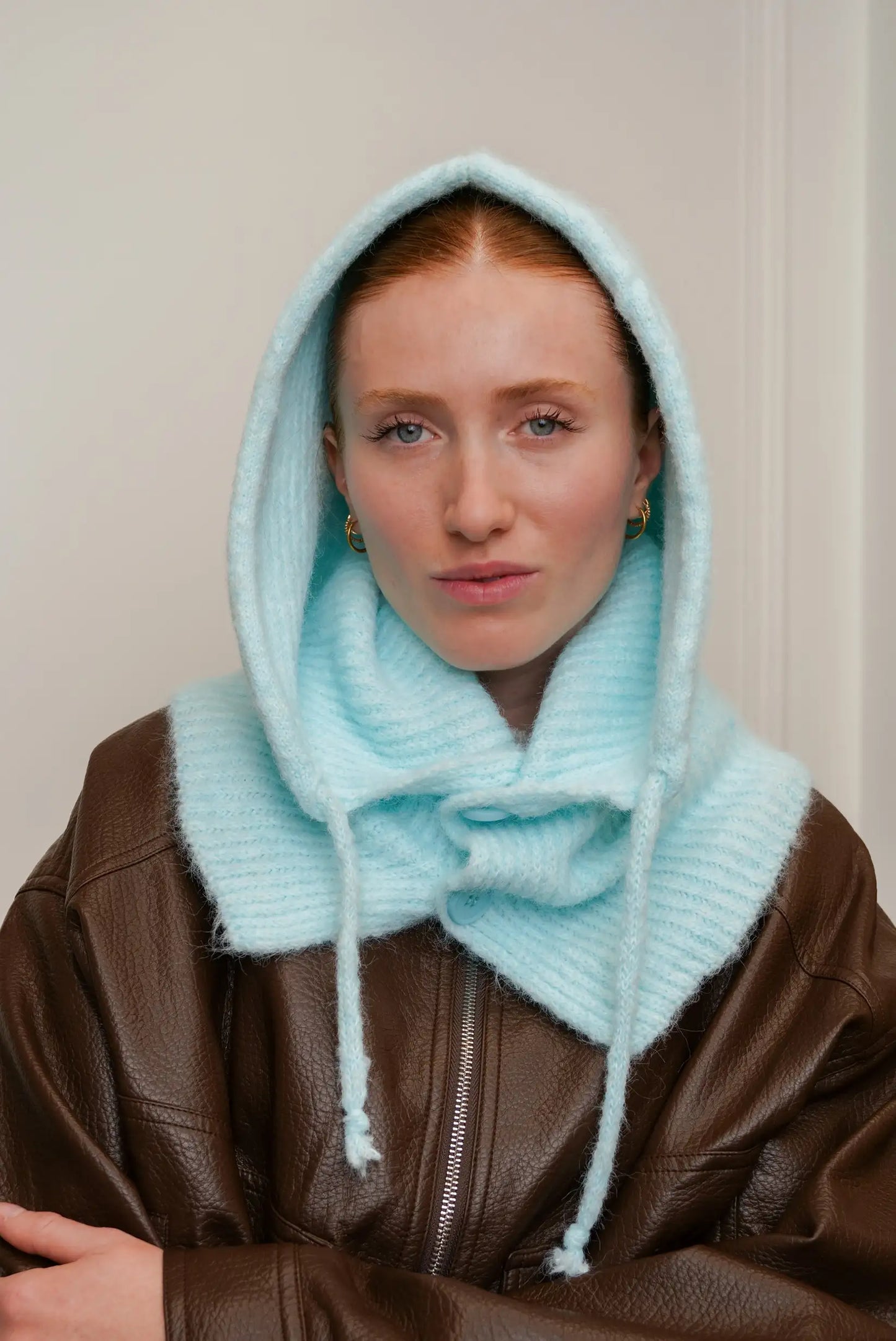 Mujer con balaclava azul cielo de punto y chaqueta marrón, moda invierno CHICA del Sur