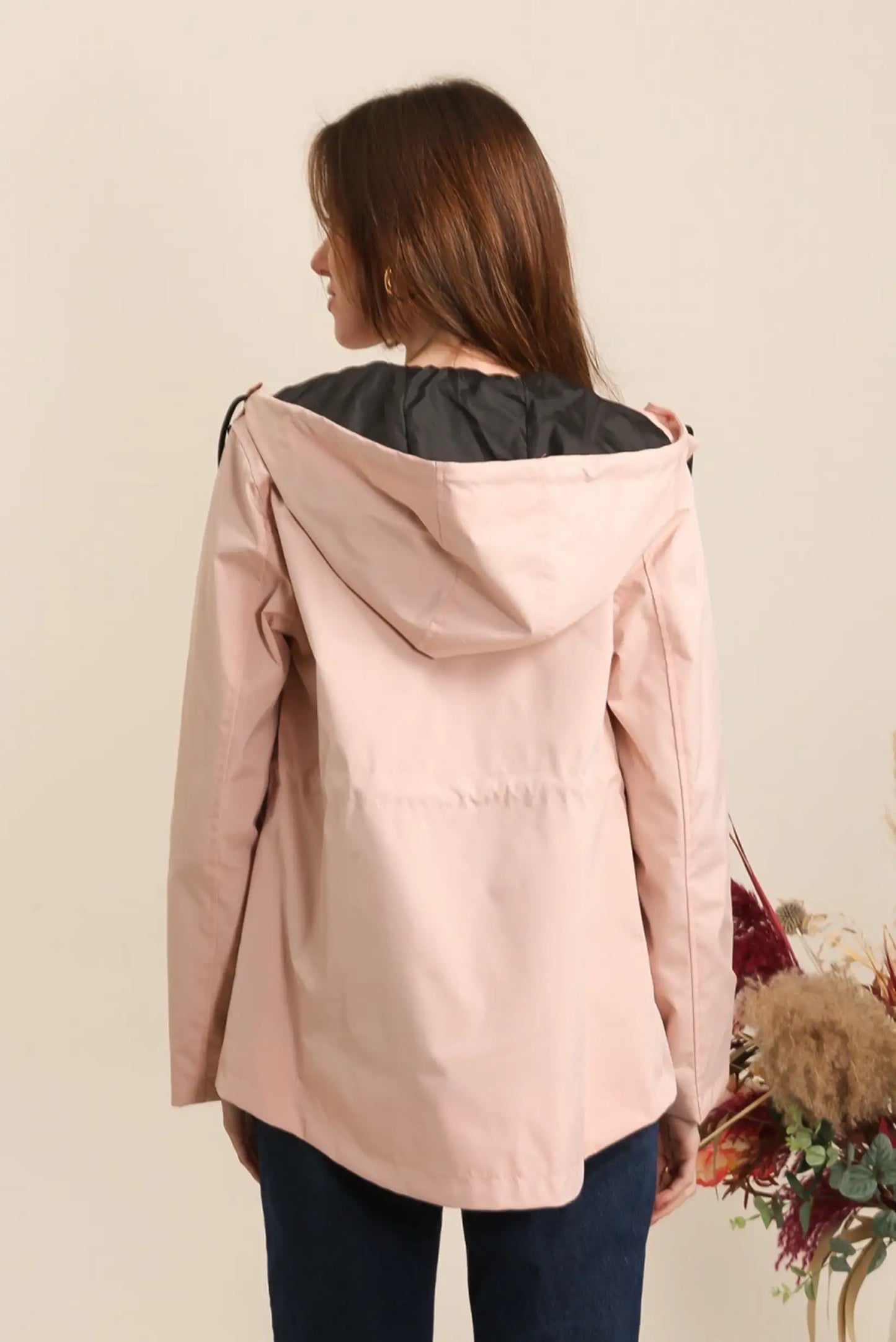 Mujer de espaldas con chubasquero corto rosa, moda casual CHICA del Sur
