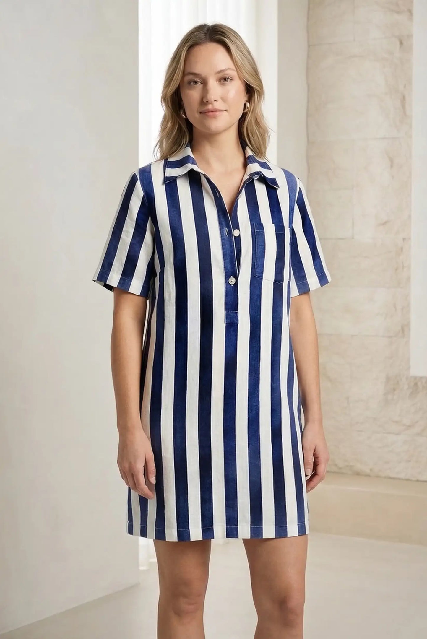 Vestido corto de mujer con rayas verticales azul marino y blancas, manga corta y cuello camisero.