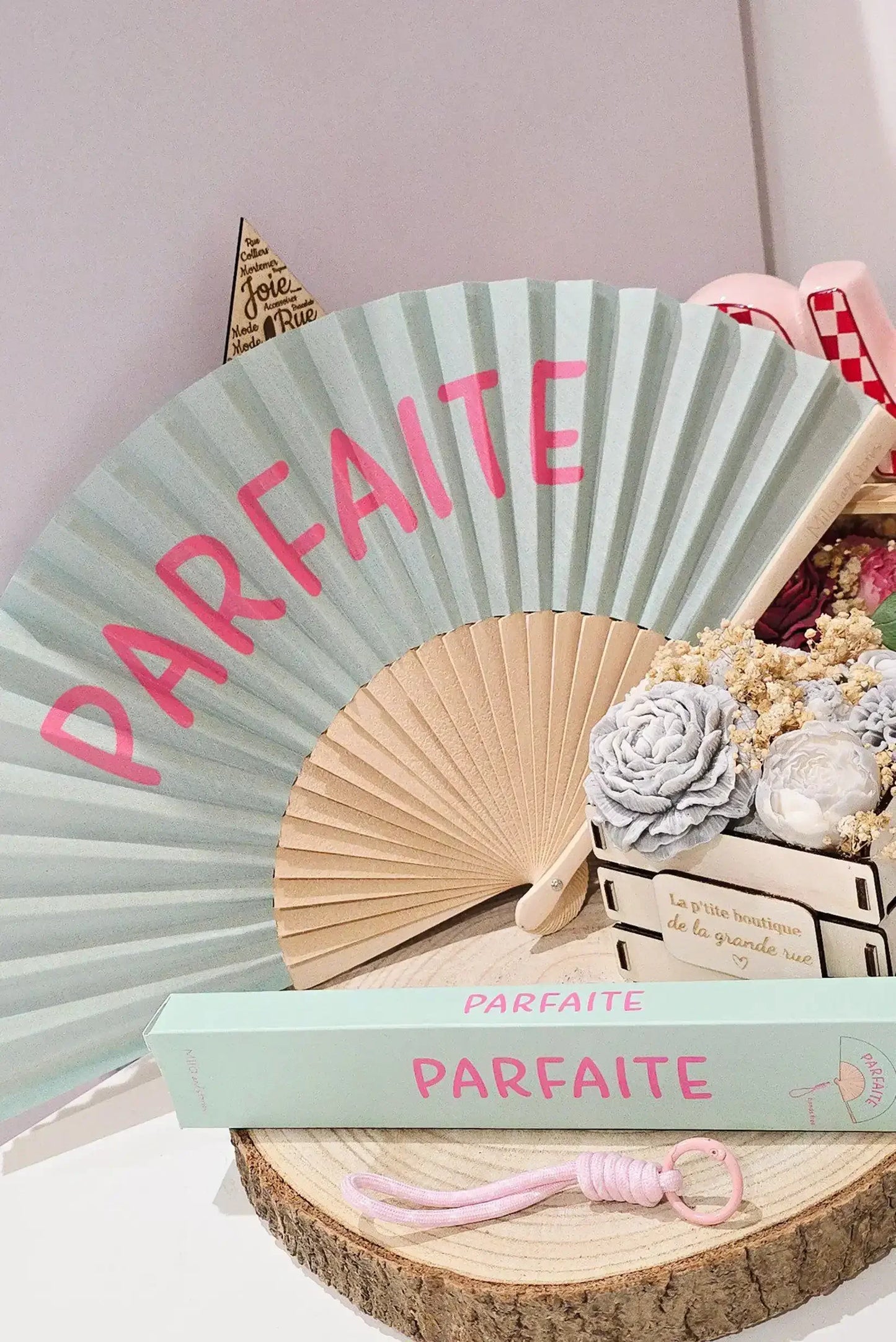 Abanico 'Parfaite' en tonos pastel con flores secas y accesorios femeninos, ideal para looks casuales y estilosos.