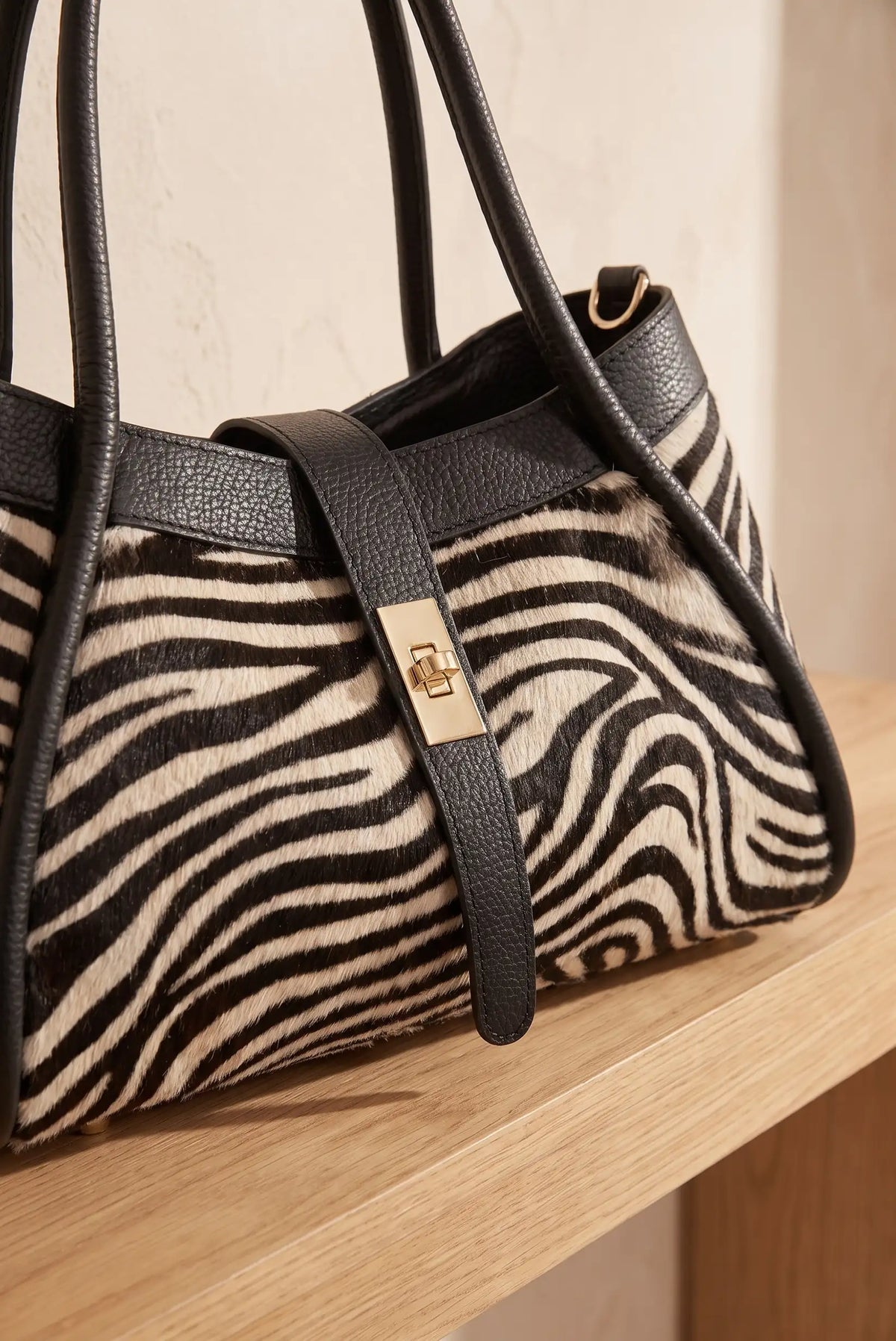 Bolso de mujer CHICA del Sur con estampado de cebra en pelo de potro y detalles en cuero negro.