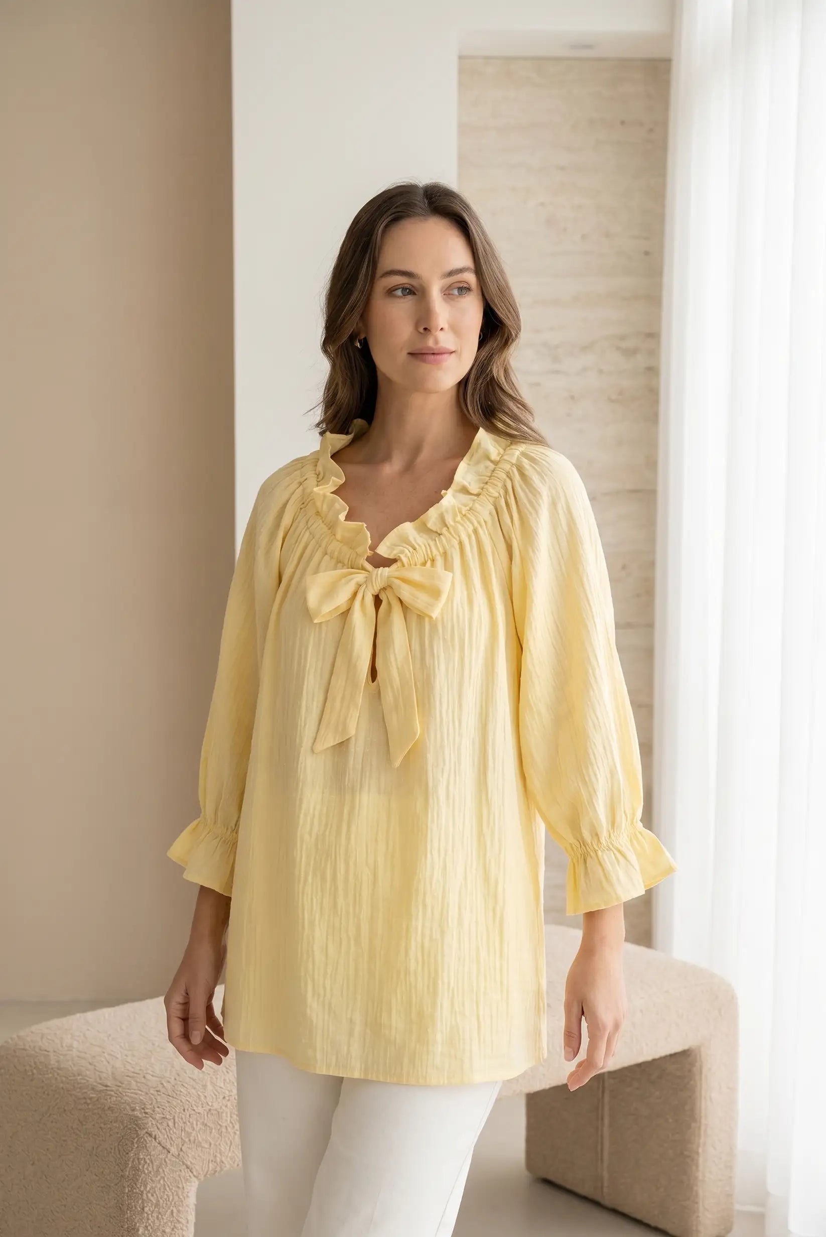 Camisa amarilla de mujer con manga francesa, volantes y lazo en el escote, estilo casual.