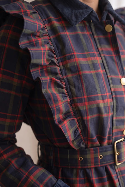 Detalle de chaqueta femenina a cuadros rojos y azules con volantes y cinturón