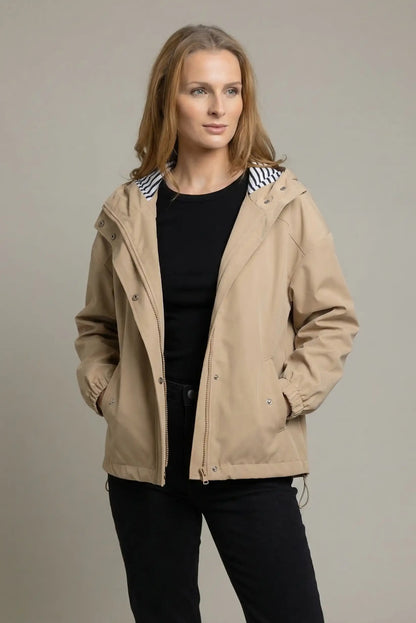 Chubasquero corto beige de mujer con capucha y forro de rayas, look casual moderno