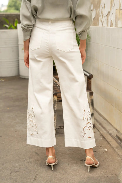 Pantalón blanco de mujer tipo palazzo con bordados florales en las piernas, estilo casual