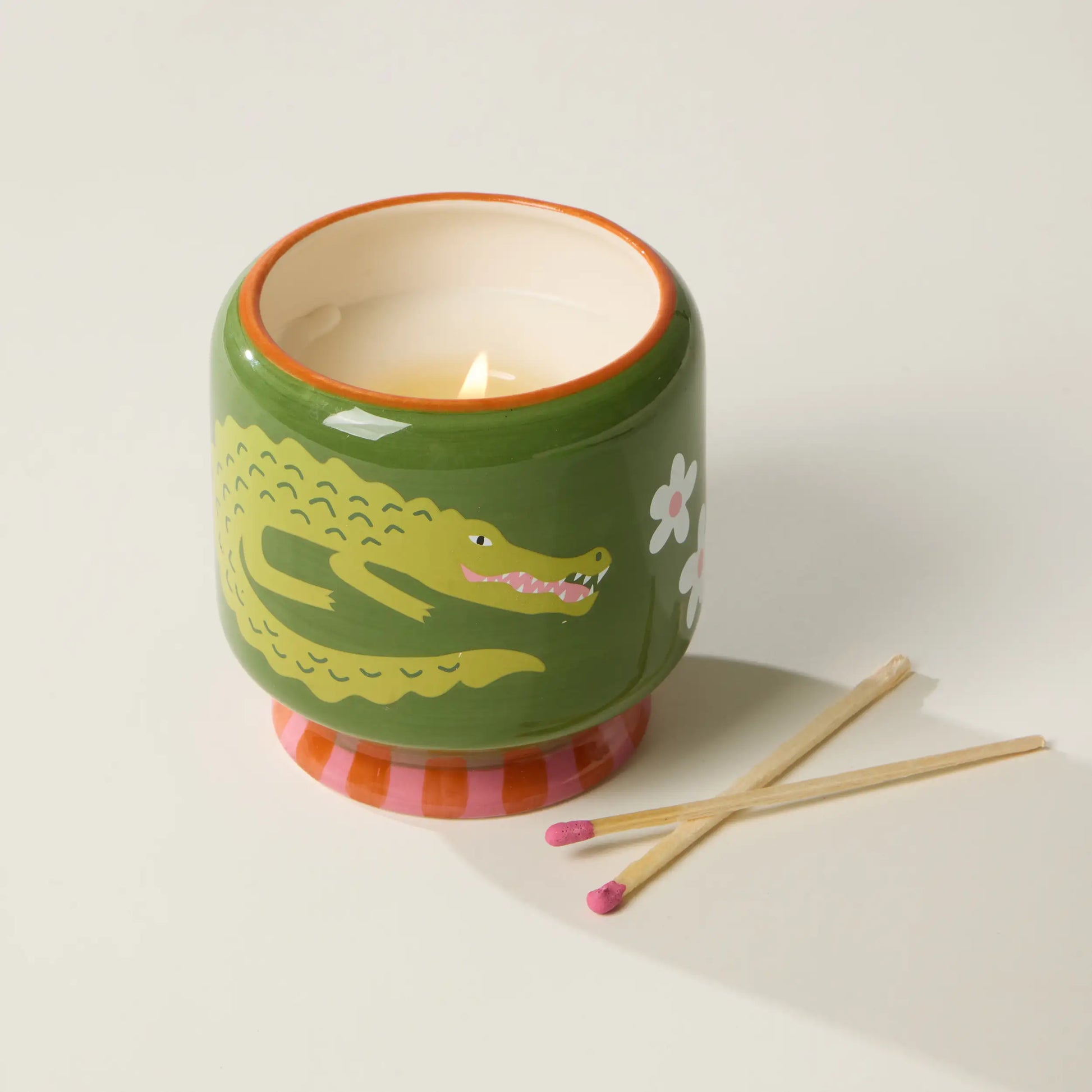 Vela decorativa Paddywax verde con diseño de cocodrilo y flores, junto a cerillas, CHICA del Sur