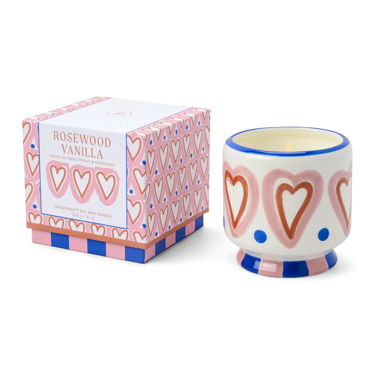 Vela aromática Paddywax Rosewood Vanilla en vaso decorado con corazones, junto a su caja rosa, ideal para CHICA del Sur.