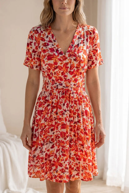 Vestido floral rojo y naranja con cuello en V y manga corta, ideal para looks casuales y estilosos.