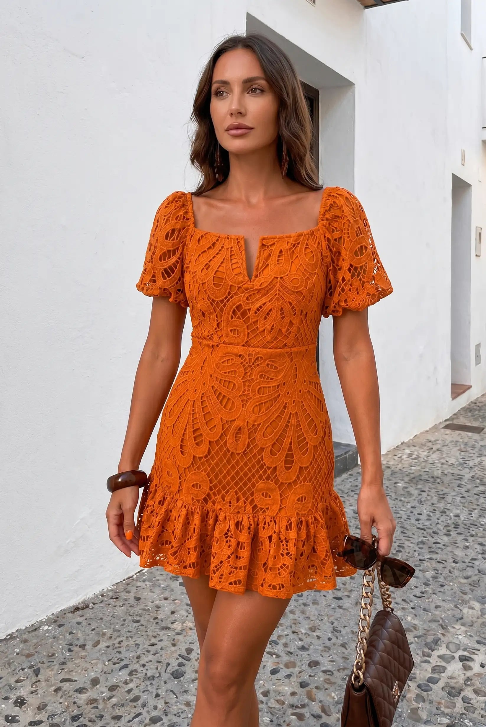 Mujer con vestido corto naranja de encaje y volantes, ideal para primavera-verano, moda casual